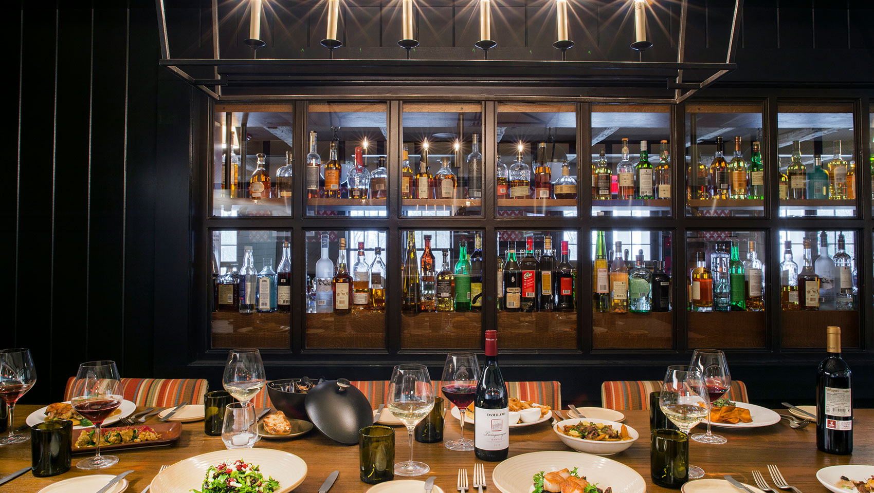restaurant dinner table setup with bar in the background