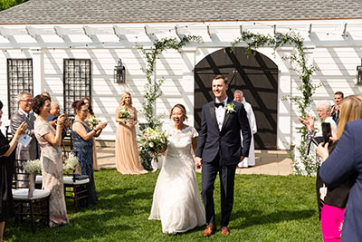 Bride and groom walking away from the aisle