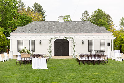 Wedding reception set up with arch, chairs, and aisle at Kimpton Taconic Hotel