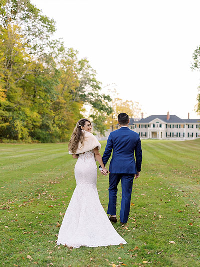 Wedding couple walking towards Kimpton Taconic Hotel